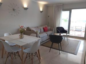 a living room with a white table and chairs at Golfside Luxury at Las Colinas in Orihuela Costa +29 photos