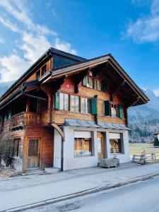 a large wooden house on the side of the street at Cozy chalet in Kandersteg in Kandersteg
