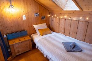 a room with a bed in a wooden cabin at Cozy chalet in Kandersteg in Kandersteg