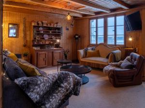 a living room with couches and a table at Cozy chalet in Kandersteg in Kandersteg