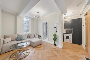 a living room with a couch and a table at Cambridge Court Central Flats in London