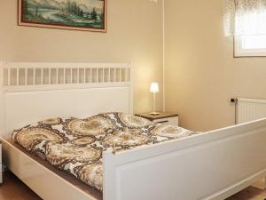 a white bed in a bedroom with a bed frame at 5 person holiday home in Billingfors in Billingsfors