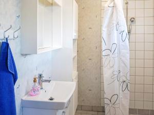 a bathroom with a sink and a shower curtain at 5 person holiday home in Billingfors in Billingsfors +19 photos