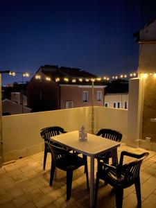 a table and chairs on a balcony at night at Casa AnnaPaola in Chioggia +28 photos