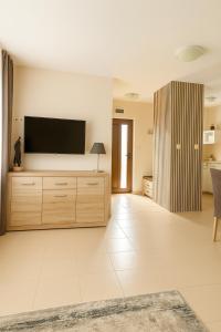 a large living room with a flat screen tv at Domček Lodenica in Šintava +8 photos