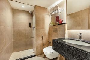 a bathroom with a toilet and a sink and a shower at Mango Hill Central Chennai in Chennai +32 photos