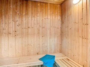 a wooden sauna with a blue towel sitting in it at 5 star holiday home in Frederiksværk in Frederiksværk