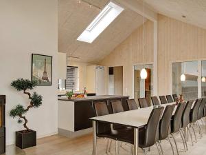 a dining room with a table and chairs and a kitchen at 5 star holiday home in Kappeln in Kappeln
