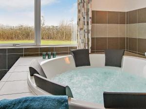 a jacuzzi tub with chairs and a window at 5 star holiday home in Kappeln in Kappeln