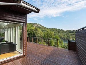 a wooden deck with a view of a mountain at 10 person holiday home in lyngdal-By Traum in Lyngdal