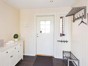 a kitchen with a white door and a window at 4 star holiday home in Lyngdal in Lyngdal