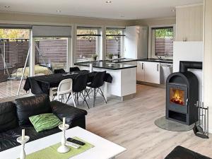 a living room with a couch and a fireplace at 4 star holiday home in Lyngdal in Lyngdal