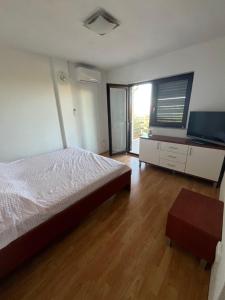 a bedroom with a bed and a flat screen tv at Vila Gioya in Karlobag