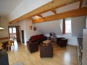 a living room with a couch and a table at Apartment St Margarethen near Ski Lift in Sankt Margarethen im Lungau