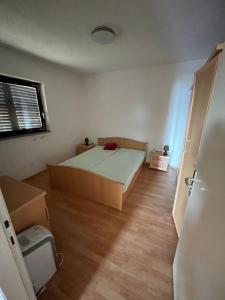 a small bedroom with a bed and a window at Vila Gioya in Karlobag +23 photos