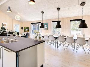 a kitchen and living room with a table and chairs at 5 star holiday home in Nexø in Bedegård