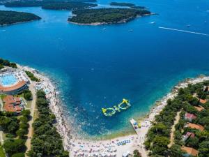 an aerial view of a beach with a yellow object in the water at Holiday Home in Vodnjan near the Sea in Vodnjan +31 photos