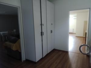 a bedroom with white cabinets and a sliding door at Casa Corvinia in Hunedoara +4 photos
