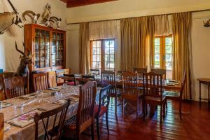 a dining room with a long table and chairs at Grootdraai Guest Farm in Adelaide