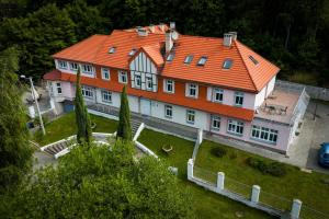 a large house with an orange roof at Dworek Szumilas in Prudnik