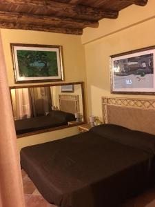 a bedroom with a bed and a mirror at Junior Suite Cattedrale in Palermo