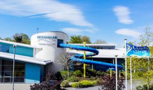 a blue building with a slide in front of it at Simply Stay in Monaghan