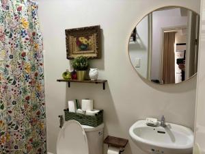 a bathroom with a sink and a mirror and a toilet at Cozy 1-BR Unit at The Loop CDO in Pontud +17 photos