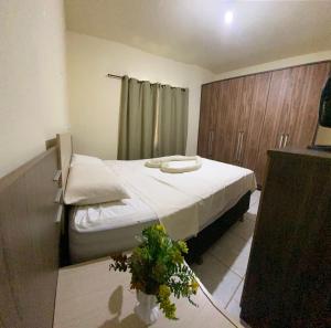 a bedroom with a bed with white sheets on it at Casa verde in Alcobaça +12 photos