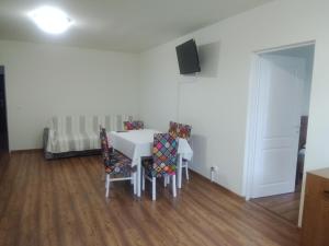 a dining room with a white table and chairs at Casa Corvinia in Hunedoara