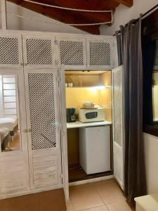 a kitchen with a white cabinet with a microwave at Studio by the sea in Santa Ponsa