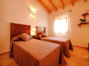 a hotel room with two beds and a window at Villa in Mallorca with Private Pool in Marratxi