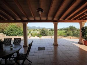 a patio with a table and chairs and a roof at Villa in Mallorca with Private Pool in Marratxi