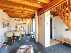 a tiny house with a dining room and kitchen at Holiday Home near Beach with Pool Access in Burgh Haamstede +32 photos