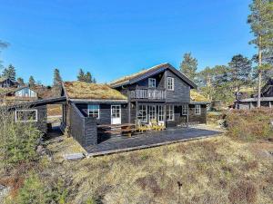 a house with a roof that has a deck at 10 person holiday home in ÅSERAL in Åseral
