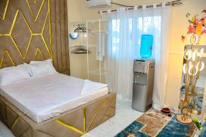 a bedroom with a bed and a television in it at Le Cristal de Roche in Pointe-Noire