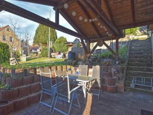 a patio with a table and chairs under a roof at Easy Access to Local Highlights in Naumburg