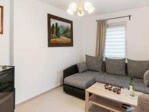 a living room with a couch and a table at Easy Access to Local Highlights in Naumburg