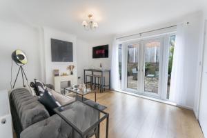 a living room with a couch and a sliding glass door at City Centre House with Secure Driveway Parking, Neflix, Garden, Long Stay Savings in Liverpool