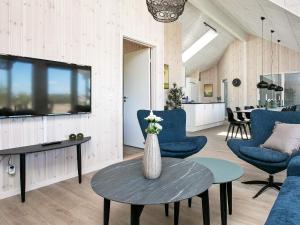 a living room with blue chairs and a table at Luxury Retreat in Marielyst - By Traum Ferienwohnungen in Marielyst +34 photos