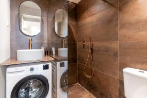 a bathroom with a washing machine and a mirror at Modern 2-Room Apartment on Monaco Border - Premium Amenities and Elegant Design in Beausoleil +13 photos