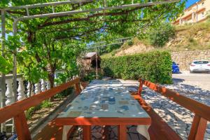 a table on the balcony of a house at Apartments Tariba in Supetarska Draga