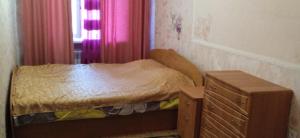a small bedroom with a bed and a dresser at Квартира 2х-комнатная посуточно in Kryvyi Rih