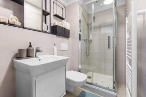 a bathroom with a toilet and a sink and a shower at Modern and Cozy flat with Balcony in Bratislava
