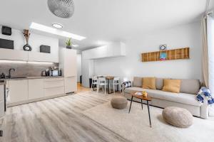 a living room with a couch and a kitchen at Modern and Cozy flat with Balcony in Bratislava +14 photos