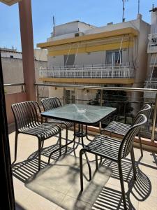 a table and chairs on a balcony with a building at SnappyB Living Spaces in Alexandroupoli +46 photos