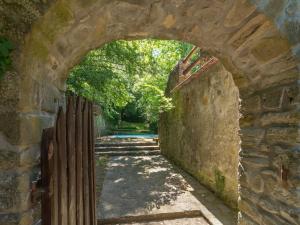 an archway in a stone wall with a fence at Spacious Villa Retreat in San Marcello Pistoiese +32 photos