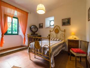a bedroom with a bed and a desk and a window at Spacious Villa Retreat in San Marcello Pistoiese