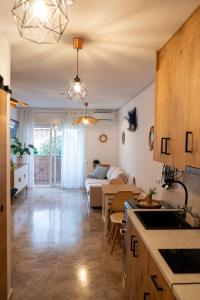 a kitchen and a living room with a couch at CT 394 - Faro's Beach & Town - Torremolinos in Torremolinos
