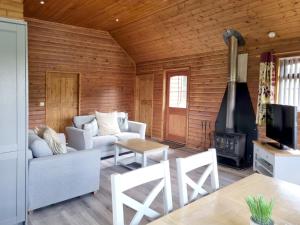 a living room with a couch and a fireplace at Oak 10 Hot Tub in Garton