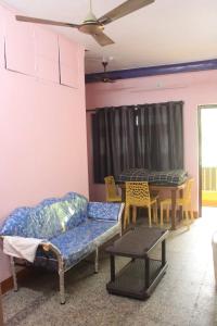 a living room with a couch and a table at Villa Lune Home Stay in Puducherry